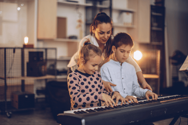 Family playing a musical instrument together and enjoying time as a group.