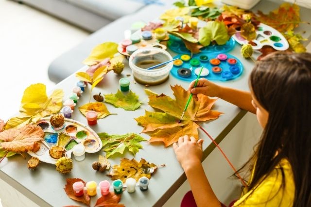 Child painting leaves