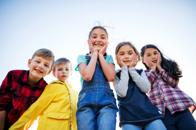 Group of happy foster children smiling together in a supportive learning environment.